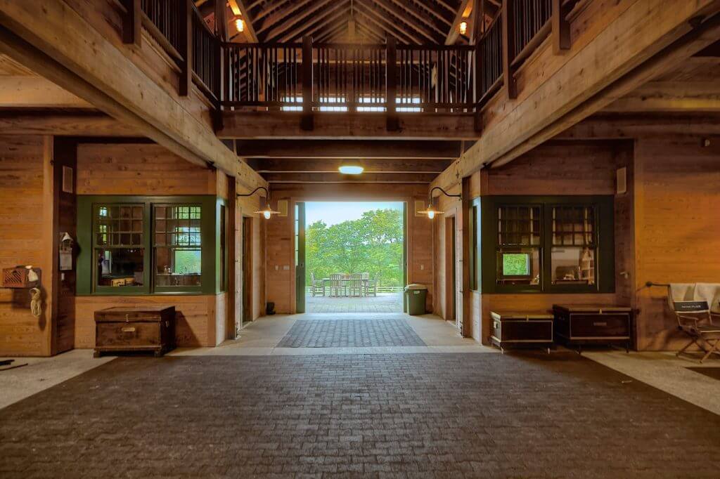 Stable Interior - Welcoming area with 2 stories, wood and green accents