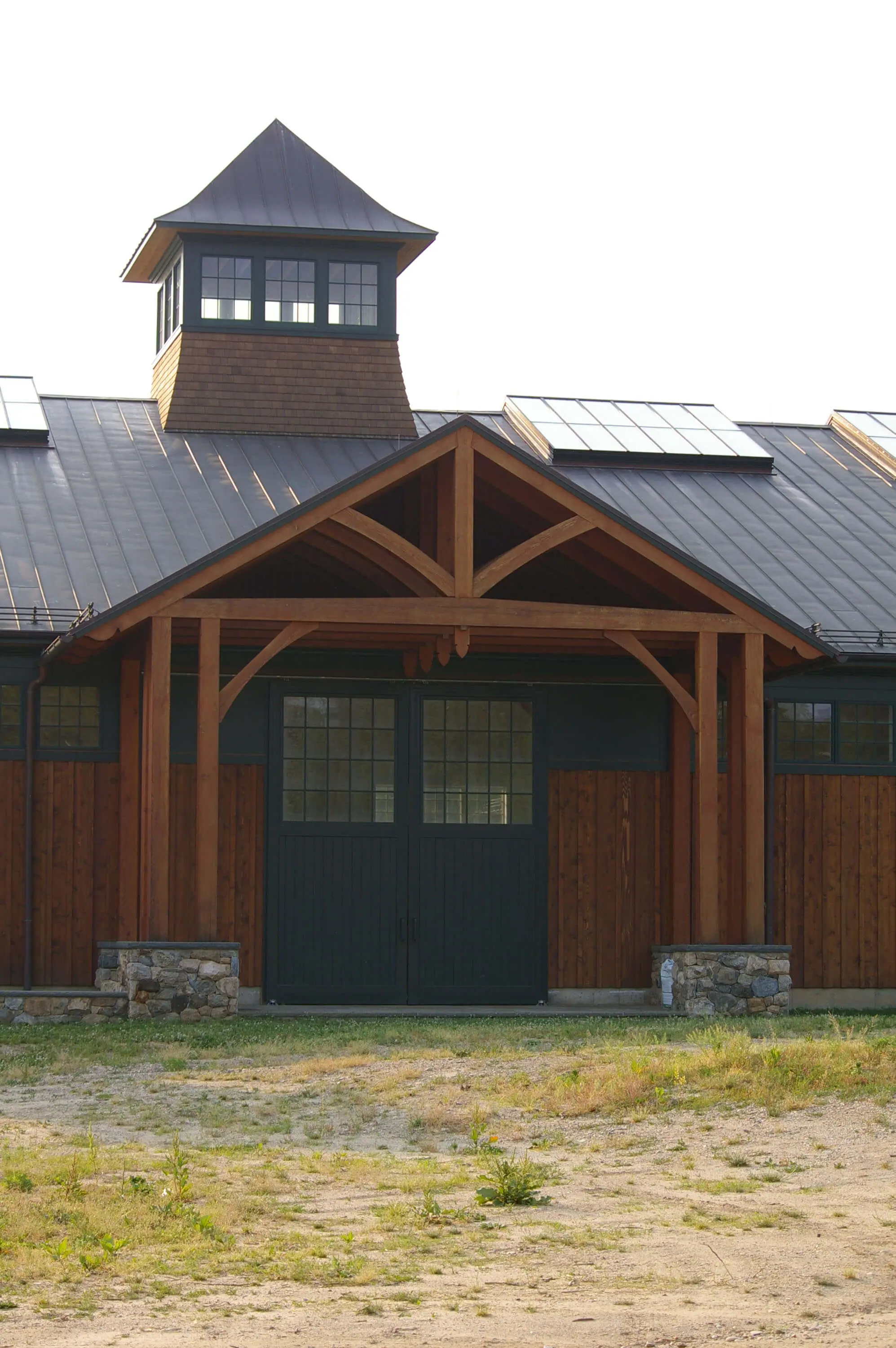 Custom Wood Clad Riding Arena with Dark Green Accents