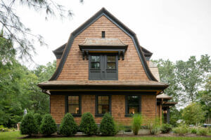 Intricate details and hip roof complete this dutch barn like residential home