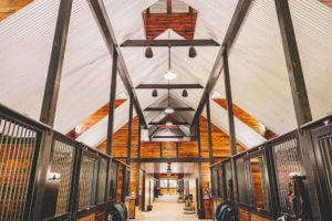 Bright Interior of a custom indoor horse barn stable