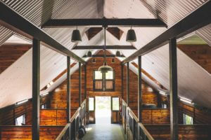 Bright Interior with Metal Roof and wood wall interior of a custom horse stable