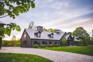 View of a custom horse stable built by Old Town Barns at sunset