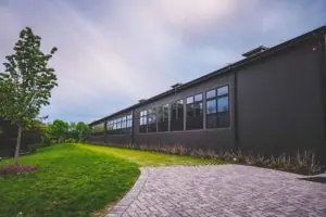 Outside of a custom indoor riding arena by Old Town Barns